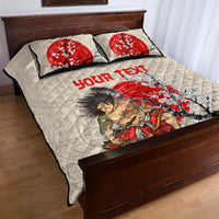 Beige quilt bed set with samurai and cherry blossom design, red text on quilt; 2 pillows