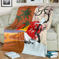 Brown blanket with palm trees, cherry blossoms, and a blue mountain graphic