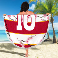 Fringed round beach blanket held up, red/white sakura print with large 10 in center