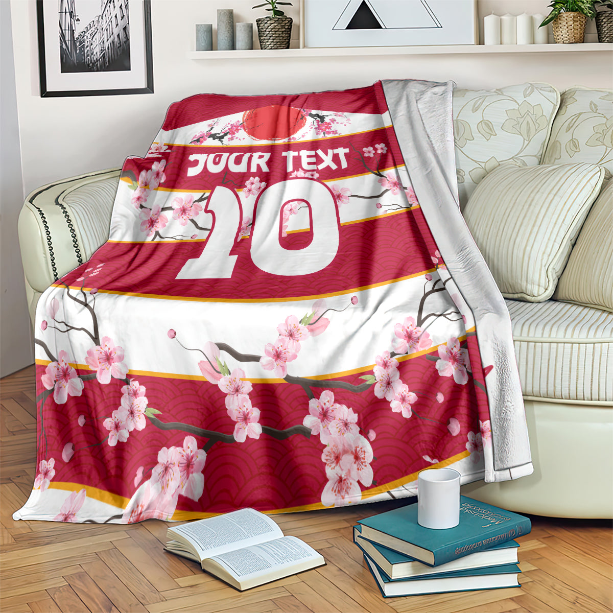 Red and white rugby blanket draped over couch, 'Your text 10' cherry blossom design