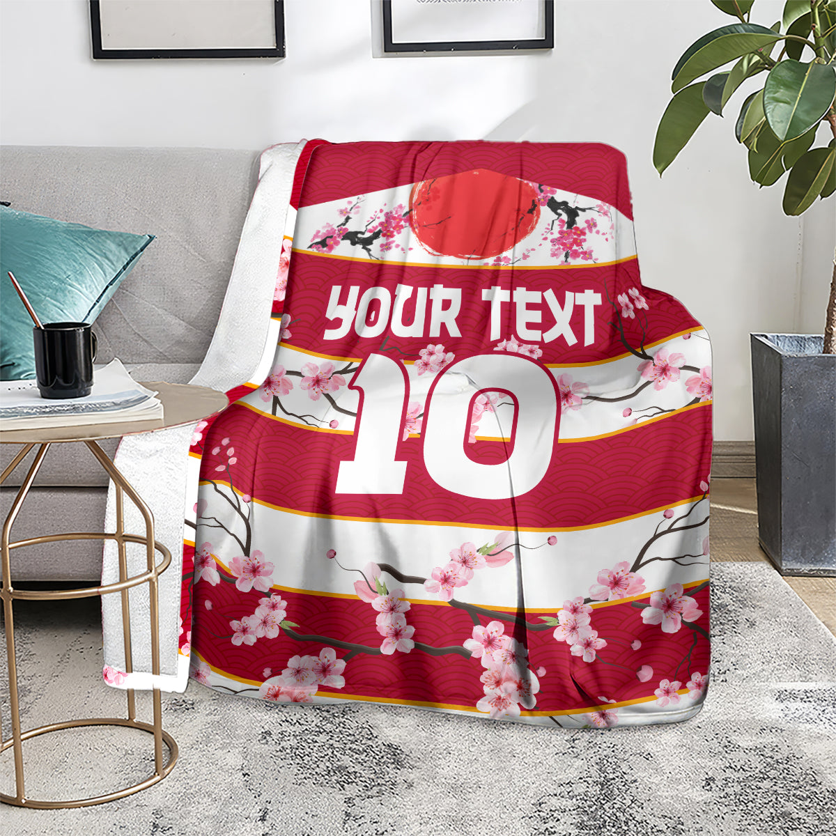 Red rugby blanket on gray chair, 'Your text 10' with pink cherry blossom border