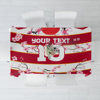 Red and white cherry blossom tablecloth with large “10” and gold stripe details