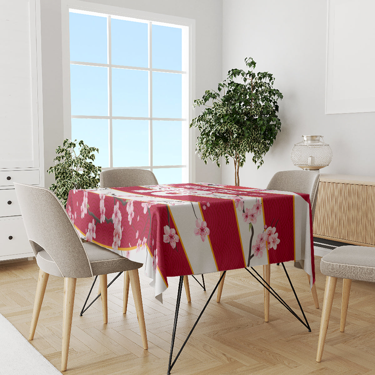 Red cherry blossom tablecloth with gold diagonal accents and pink flower print on a table