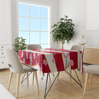 Red cherry blossom tablecloth with gold diagonal accents and pink flower print on a table