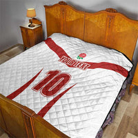 White bed quilt with red diagonal stripe, rose emblem, YOUR TEXT, and large 12
