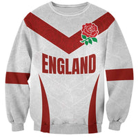 White rugby-style sweatshirt with red chevron, England lettering, and red rose emblem