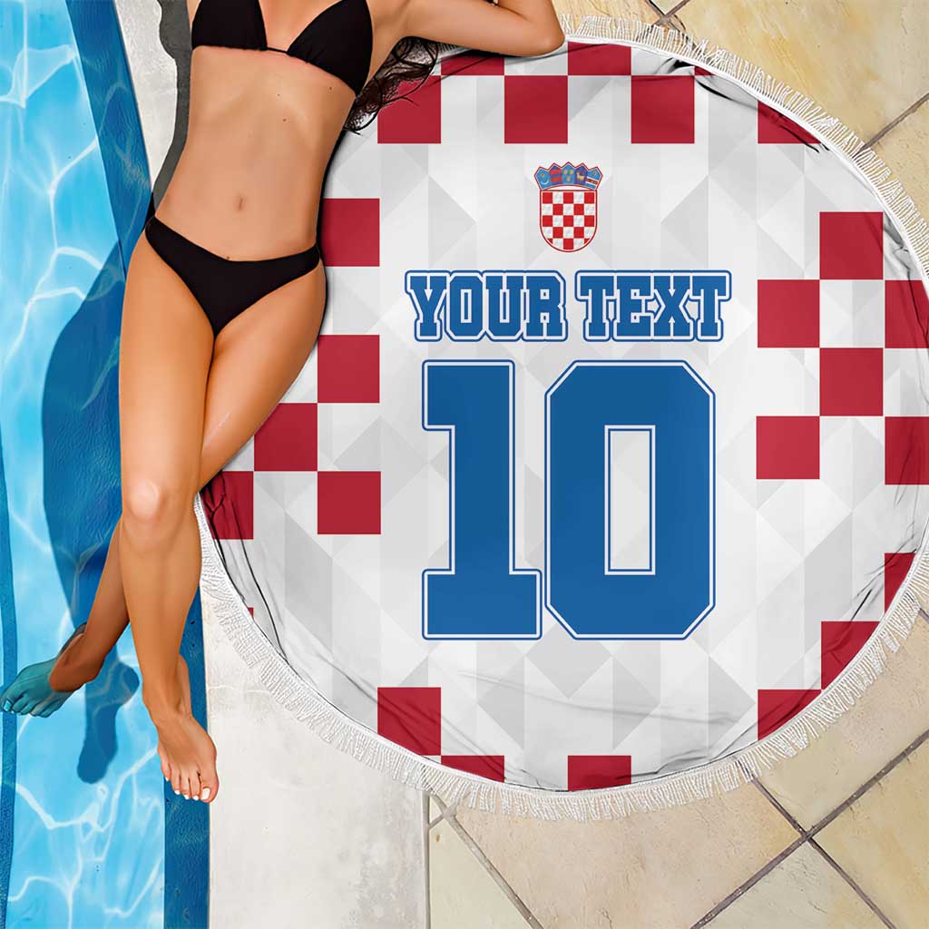 Round Croatia beach blanket over pool tiles, red check flag with blue 10 print and fringe