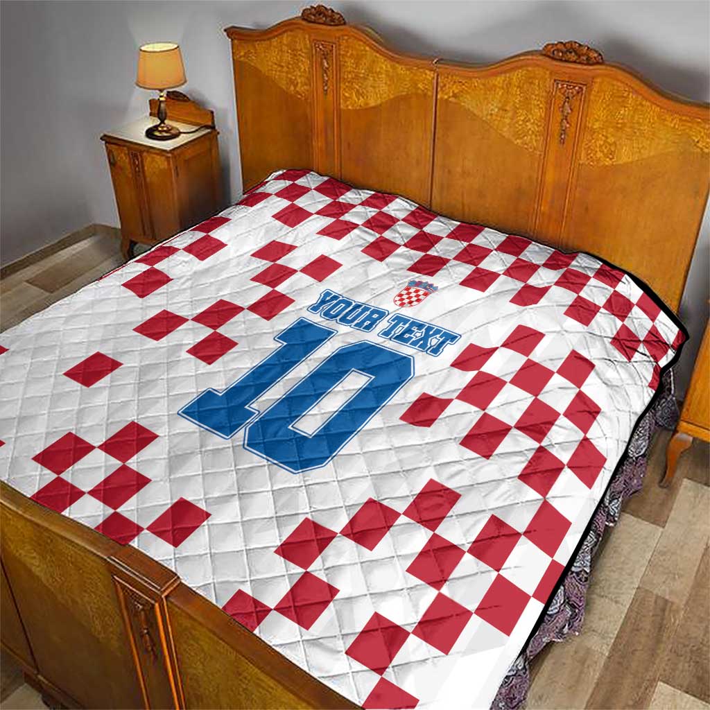 Custom quilt on bed: white with red checker pattern and blue number 10 print