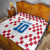 Custom quilt on bed: white with red checker pattern and blue number 10 print