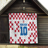 Custom quilt hanging outdoors with white/red check pattern and blue number 10