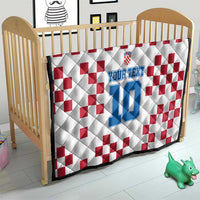 Custom quilt in nursery: white with red check pattern and blue number 10 design