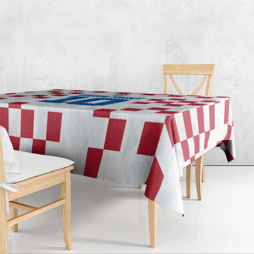 Custom white tablecloth with red and white check pattern draped over dining table