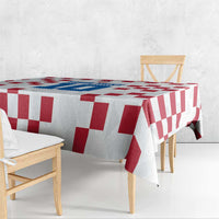 Custom white tablecloth with red and white check pattern draped over dining table
