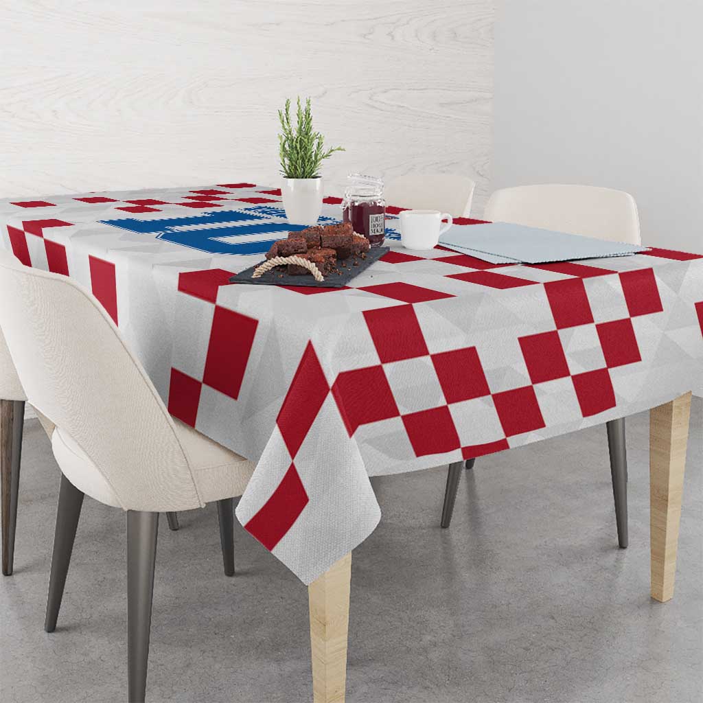 White tablecloth with red checkerboard pattern covering square dining table