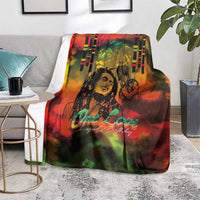 Reggae-themed blanket over light gray chair, reggae legend portrait with 'One Love' script