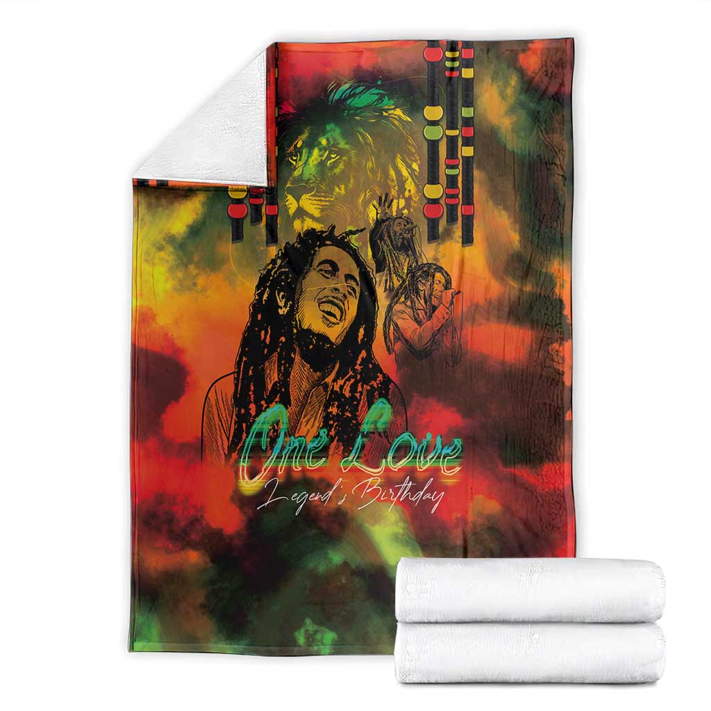 Reggae-themed blanket folded with white towels, reggae legend portrait and 'One Love' text