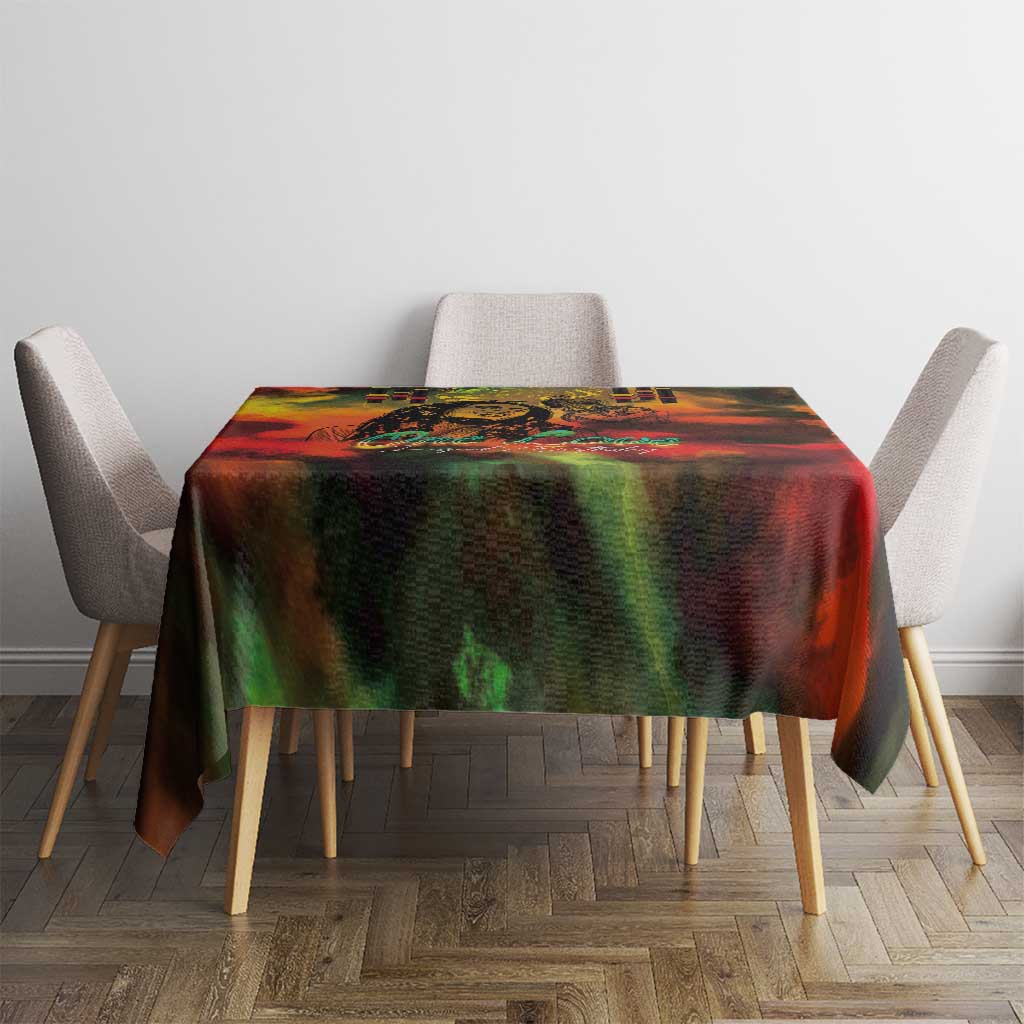 Reggae-themed tablecloth with vivid red, green and black print on a small dining set