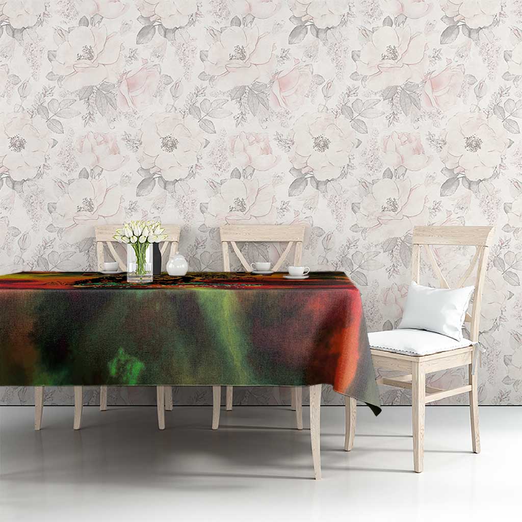 Reggae-themed tablecloth with red, green and black abstract design on dining table with chairs