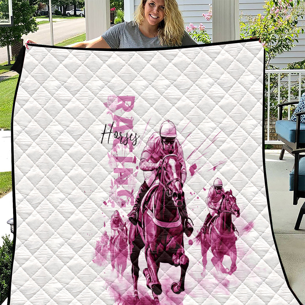 White quilt with diamond quilting and pink jockey graphic, spread flat outdoors