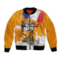 Orange bomber jacket with front zipper and graphic patch design, ribbed collar and cuffs