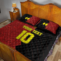 Red/black quilt bed set with yellow 'YOUR TEXT' and large '10', on bed with pillows