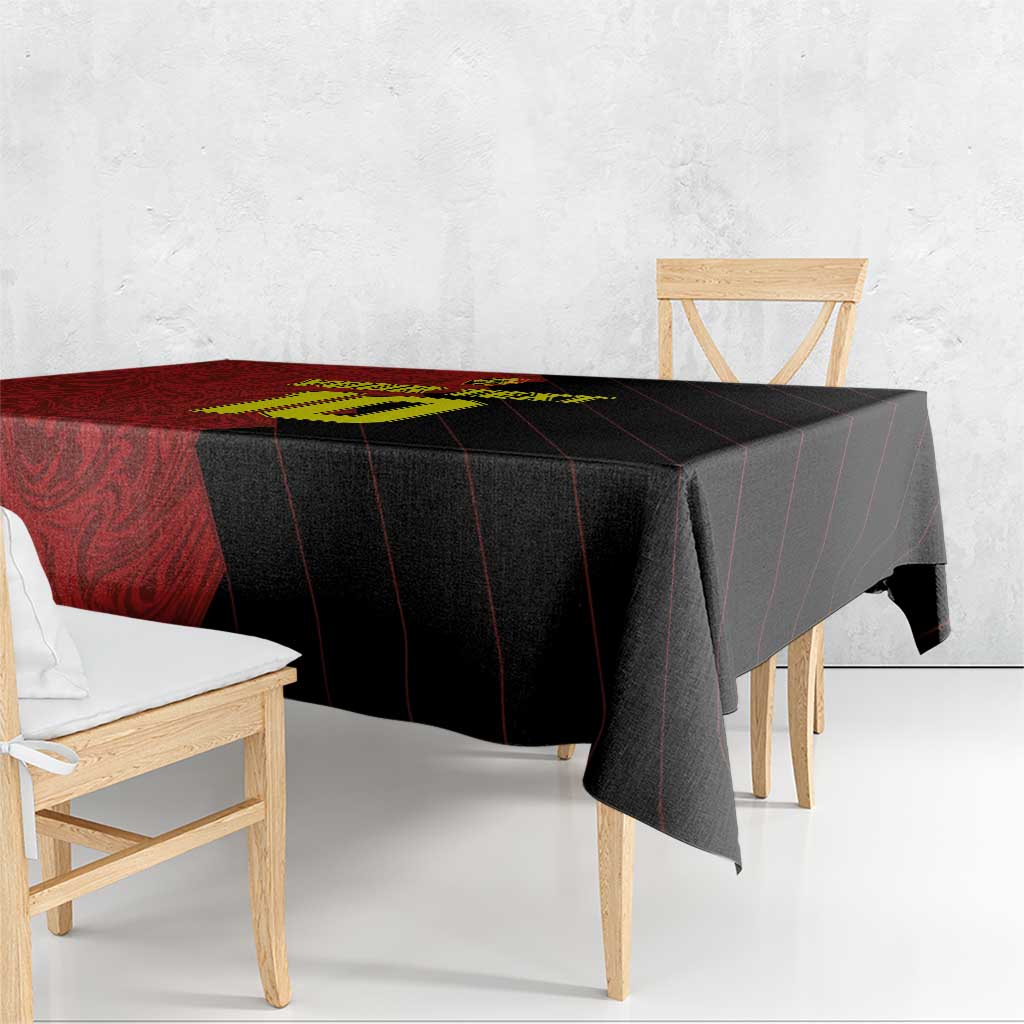 Red and black tablecloth draped over a wooden table, diagonal stripe pattern