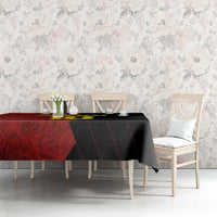 Red and black football tablecloth on dining table with matching chairs