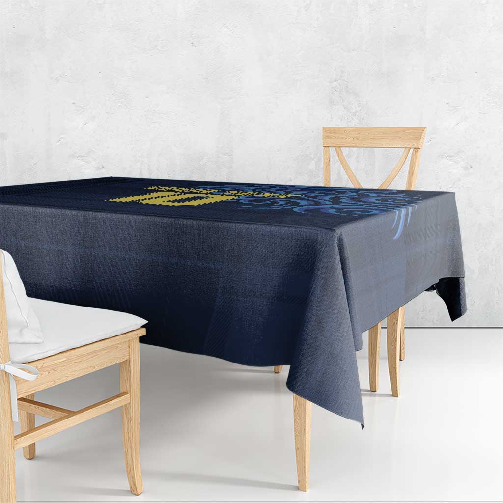 Navy blue tablecloth corner with yellow emblem and blue swirl graphic
