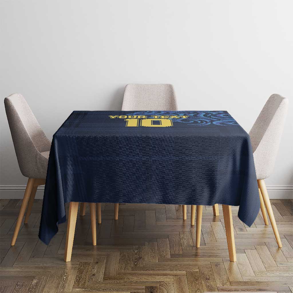 Navy blue tablecloth with yellow emblem and blue swirl pattern on dining table