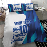 Close-up view of blue and teal football bedding set featuring lion crest, 'YOUR TEXT' and number 10