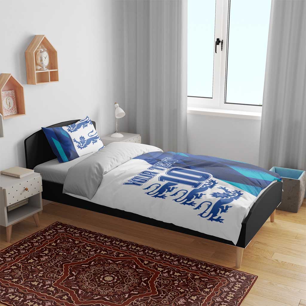 Blue and teal bedding set on bed with lion crest, 'YOUR TEXT' and number 10, and matching pillows