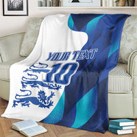 Custom football blanket on a sofa with white, blue and teal graphic and “YOUR TEXT” “10”