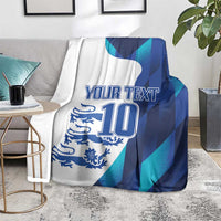 Custom football blanket on a living room rug with “YOUR TEXT” and “10” on blue teal design