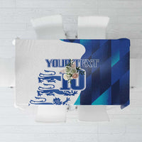 Blue and teal geometric tablecloth with England crest-style emblem and text area
