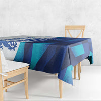 Blue and teal geometric tablecloth with draped corners on wooden table
