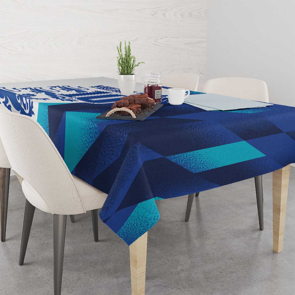 Blue and teal graphic tablecloth with draped edge on dining table