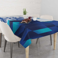 Blue and teal graphic tablecloth with draped edge on dining table