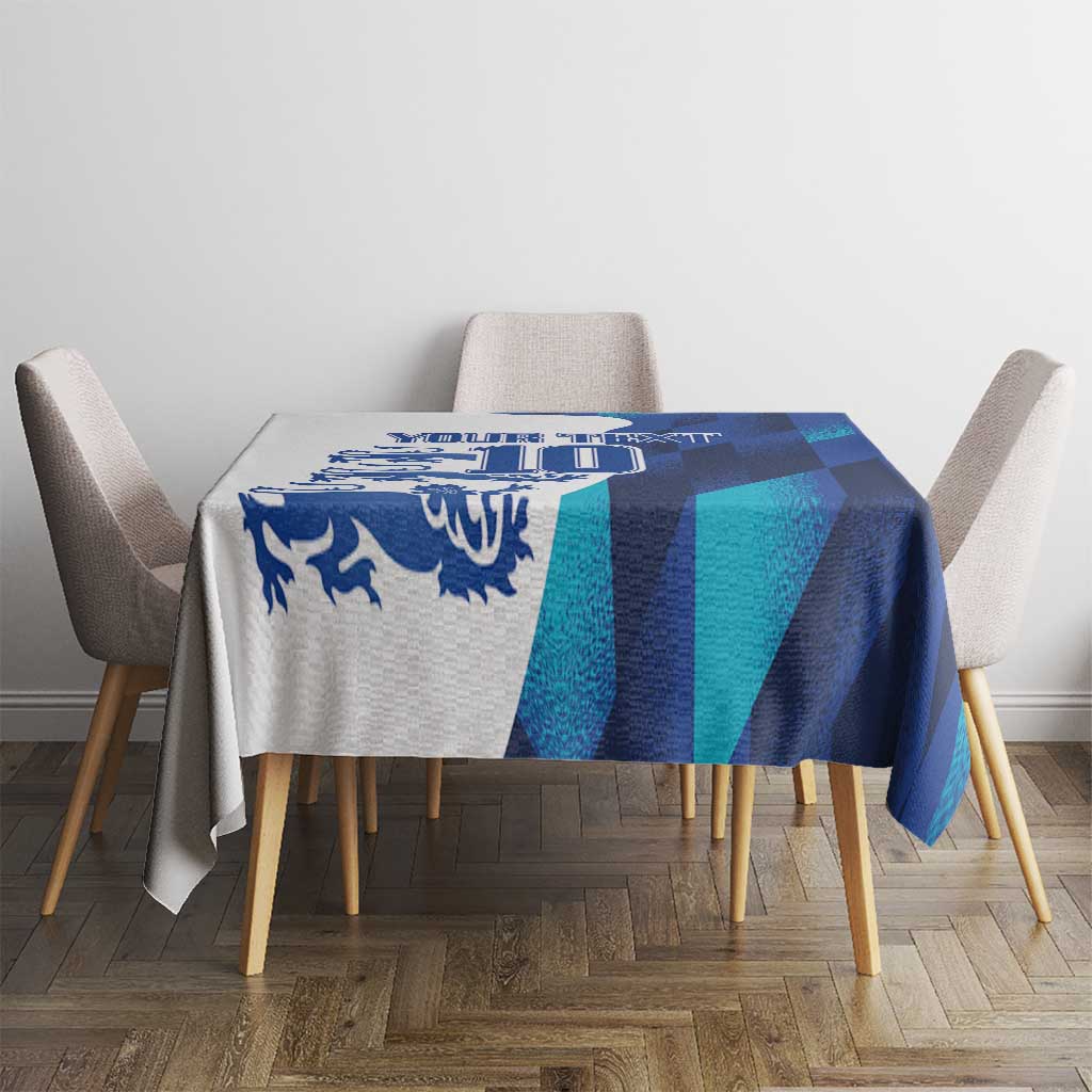 Blue and teal geometric tablecloth draped over dining table with chairs