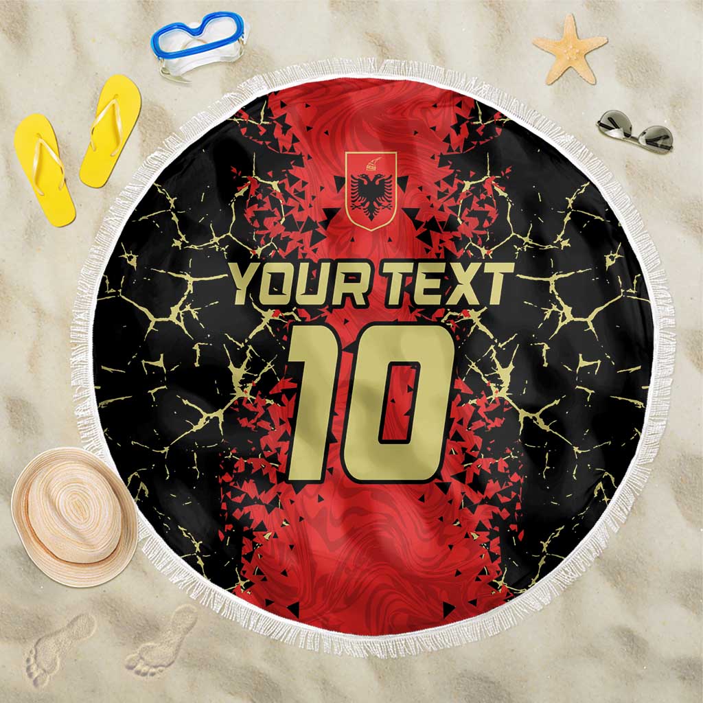 Round beach blanket with black background, red crest graphic, “YOUR TEXT”, and white fringe