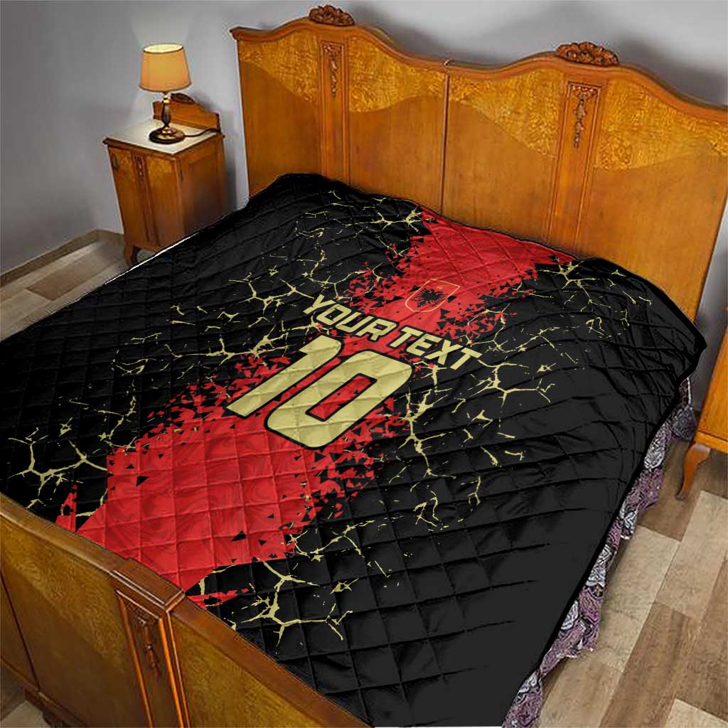 Quilt blanket on bed showing black and red football jersey graphic, number 10, and “YOUR TEXT”.