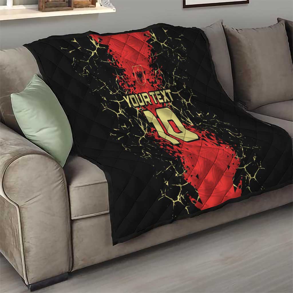 Quilt blanket on sofa with black and red football jersey graphic, number 10, and “YOUR TEXT”.