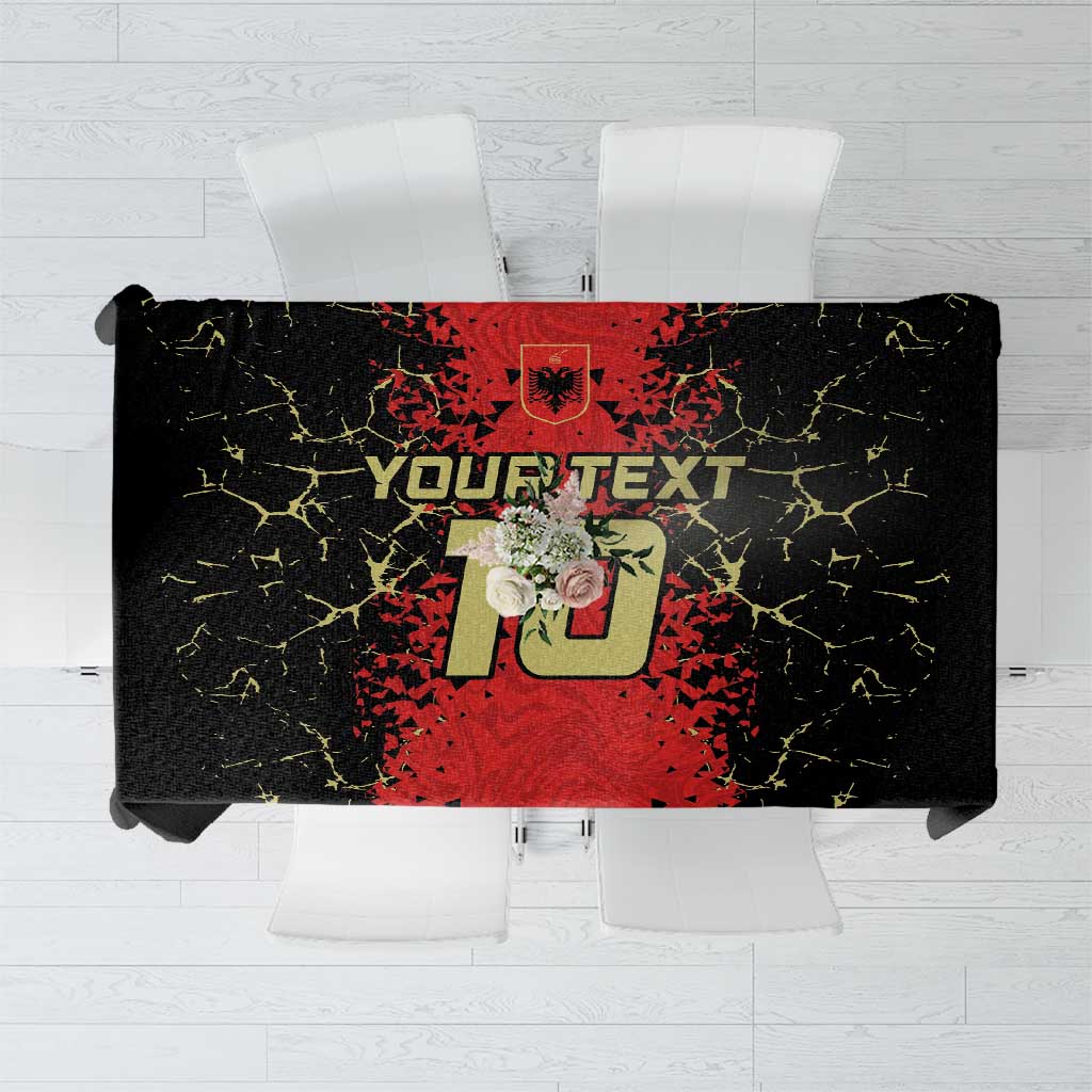 Custom tablecloth featuring bold red logo text graphic on black background with yellow crackle