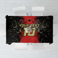Custom tablecloth featuring bold red logo text graphic on black background with yellow crackle
