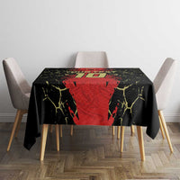 Black and red football-themed tablecloth with yellow crackle accents, on a dining table with chairs
