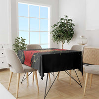 Black tablecloth with red football graphic and yellow crackle lines, spread over a rectangular table
