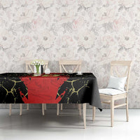 Black tablecloth with red central football graphic and yellow crackle pattern, on a dining table