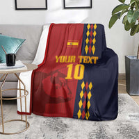 Custom Spain football blanket on a living room rug, red-and-navy lion graphic and diamond stripes