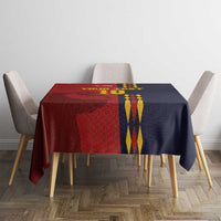 Red and navy Spain-themed tablecloth with crest and diamond emblem on tabletop.