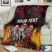 Personalized racing blanket with horse riders, roses & flames, 'YOUR TEXT' draped on sofa