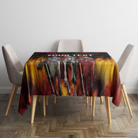 Black tablecloth with dripping flame pattern and dark rose accents across tabletop